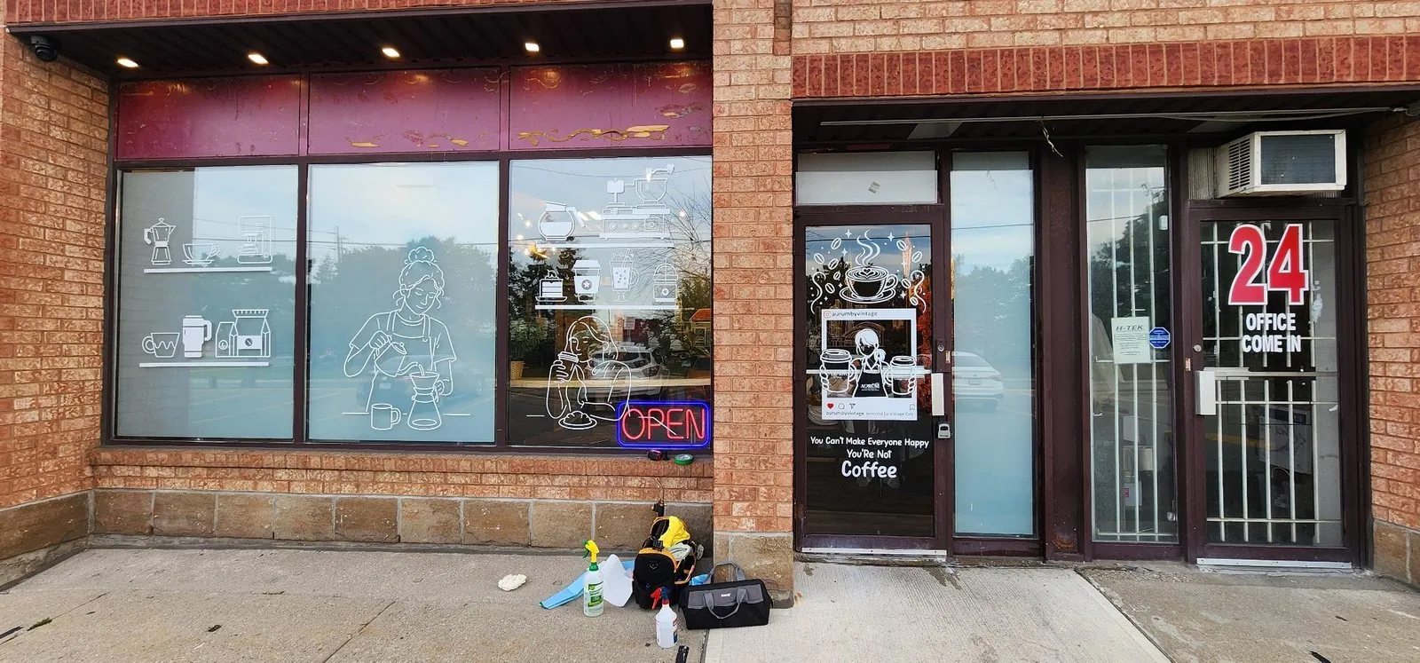 Aurum by Vintage coffee shop storefront with white window decals
